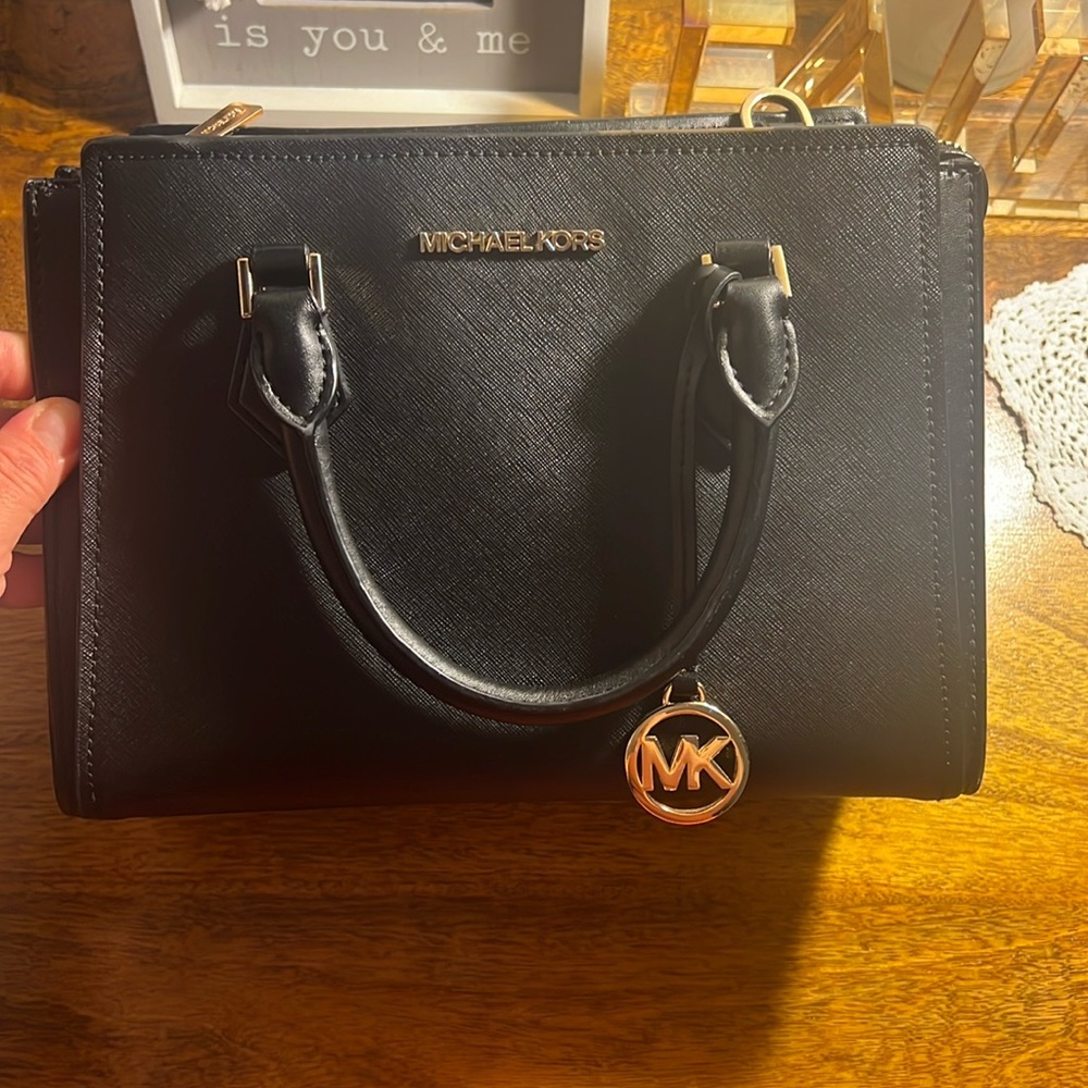 Micheal kors black shoulder/carrying purse. Gold hardware.